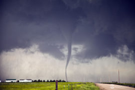 Satellite tornado moves across road.