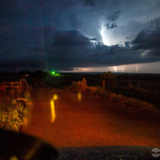 A supercell produces a tornado after dark.